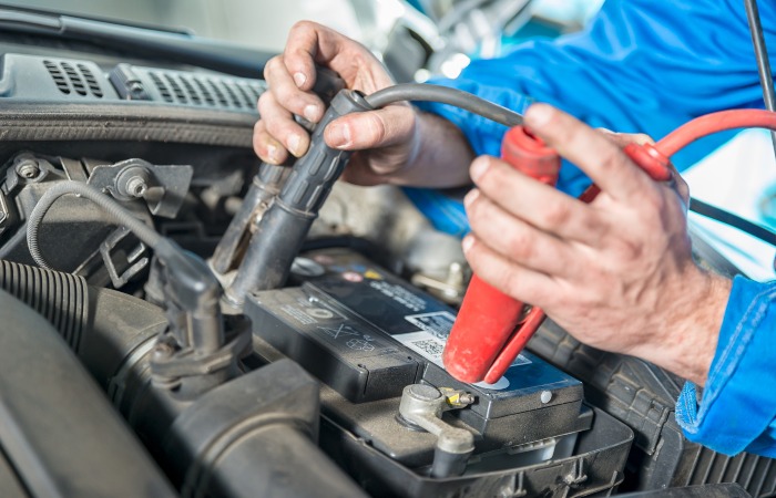 Car battery jump start by a certified technician at Stoiched Automotive